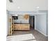 Well-lit kitchenette featuring modern wooden cabinets and wood look tile flooring at 1225 26Th N St, St Petersburg, FL 33713