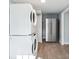 A functional laundry area with stainless steel refrigerator and a stackable washer and dryer at 1225 26Th N St, St Petersburg, FL 33713