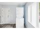 A laundry room features a stacked washer and dryer with a view of the outdoors at 1225 26Th N St, St Petersburg, FL 33713