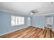 Bright living room with light blue walls, ceiling fan, and beautiful wood floors at 1225 26Th N St, St Petersburg, FL 33713