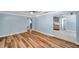 Open-concept living room with wood flooring, archways, and seamless flow to the kitchen at 1225 26Th N St, St Petersburg, FL 33713