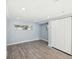 This room is bright and airy, featuring two windows, gray floors, and a closet for storage at 1225 26Th N St, St Petersburg, FL 33713