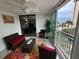 Inviting balcony with comfortable seating and a view of the ocean and palm trees at 1390 Gulf Blvd # 104, Clearwater, FL 33767