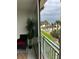 Balcony view overlooking palm trees, pool, and sandy beach at 1390 Gulf Blvd # 104, Clearwater, FL 33767