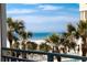 Balcony with scenic ocean view and palm trees at 1390 Gulf Blvd # 104, Clearwater, FL 33767