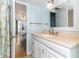 Bright bathroom featuring a white vanity, neutral countertops and a door to the bedroom at 1390 Gulf Blvd # 104, Clearwater, FL 33767