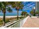 Beach access from this building showcases a white sand beach, clear water and blue skies at 1390 Gulf Blvd # 104, Clearwater, FL 33767