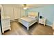 Bedroom showcasing a queen-sized bed, hardwood flooring, and neutral decor at 1390 Gulf Blvd # 104, Clearwater, FL 33767