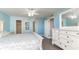 Spacious bedroom with light blue walls, white furniture, wood floors, and multiple doors at 1390 Gulf Blvd # 104, Clearwater, FL 33767