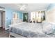 Comfortable bedroom with a balcony, light blue walls, white furniture, and plenty of natural light at 1390 Gulf Blvd # 104, Clearwater, FL 33767