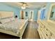 Bright bedroom with a queen-sized bed, wooden floors, and stylish decor at 1390 Gulf Blvd # 104, Clearwater, FL 33767
