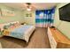 Bright bedroom with wood floors, light green walls, ceiling fan, and tropical themed decor at 1390 Gulf Blvd # 104, Clearwater, FL 33767