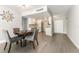 Dining area with a round table, four chairs, and unique modern art at 1390 Gulf Blvd # 104, Clearwater, FL 33767
