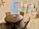 Cozy dining area with a round table, chairs, and a partial view of the kitchen at 1390 Gulf Blvd # 104, Clearwater, FL 33767