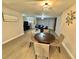Dining room with a table and seating for four, connecting to a living area at 1390 Gulf Blvd # 104, Clearwater, FL 33767