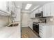 Updated kitchen with white cabinets, stainless steel appliances, and light countertops at 1390 Gulf Blvd # 104, Clearwater, FL 33767
