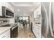 Modern kitchen with stainless steel appliances and views to the dining and living areas at 1390 Gulf Blvd # 104, Clearwater, FL 33767
