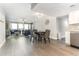 Open living area with hardwood floors, ceiling fan, dining area, and modern kitchen at 1390 Gulf Blvd # 104, Clearwater, FL 33767