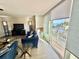 Living room with modern furniture, balcony, and beach view at 1390 Gulf Blvd # 104, Clearwater, FL 33767