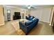 Cozy living room featuring blue sofas, a glass coffee table, and stylish decor at 1390 Gulf Blvd # 104, Clearwater, FL 33767