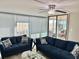 Living room with modern furniture, balcony, and a beautiful view at 1390 Gulf Blvd # 104, Clearwater, FL 33767