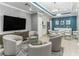 Relaxing lounge area featuring modern furniture, a dining table, and a TV for entertainment at 1390 Gulf Blvd # 104, Clearwater, FL 33767
