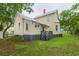 Charming yellow home with a spacious backyard and a small deck area perfect for outdoor entertaining at 14006 5Th St, Dade City, FL 33525