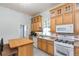 Bright kitchen features wood cabinets, patterned tile flooring, and modern appliances at 14006 5Th St, Dade City, FL 33525
