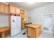 Bright kitchen features patterned tile flooring, wood cabinets, and an island at 14006 5Th St, Dade City, FL 33525