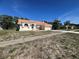 Well-kept home boasting a tile roof, an arched entryway, and a concrete driveway at 14189 Cornewall Ln, Spring Hill, FL 34609