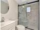 The renovated bathroom features a glass-enclosed shower with modern fixtures at 1421 Normandy Park Dr # 6, Clearwater, FL 33756