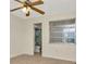 This bedroom features a ceiling fan and an accessible en suite bathroom with walk-in shower at 1421 Normandy Park Dr # 6, Clearwater, FL 33756
