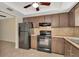 Efficient kitchen with a stainless refrigerator, stove, and dark wood cabinetry at 1421 Normandy Park Dr # 6, Clearwater, FL 33756
