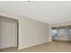 Neutral living room with closet and large windows offering natural light at 1421 Normandy Park Dr # 6, Clearwater, FL 33756