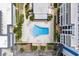 Aerial view of the pool surrounded by manicured grounds and condos at 147 Bluff View Dr # 206, Belleair Bluffs, FL 33770