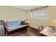 Bedroom with a window with wooden floors, a couch, and a desk at 147 Bluff View Dr # 206, Belleair Bluffs, FL 33770