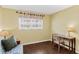 Cozy bedroom featuring a window, desk, and hardwood flooring at 147 Bluff View Dr # 206, Belleair Bluffs, FL 33770