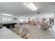 Open clubhouse with seating areas, pool table and tile floors at 147 Bluff View Dr # 206, Belleair Bluffs, FL 33770