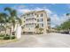 Exterior of a well-maintained condo building with manicured grounds, palm trees, and convenient parking at 147 Bluff View Dr # 206, Belleair Bluffs, FL 33770