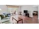 Bright living room featuring hardwood floors, balcony access, and open layout to the bedroom at 147 Bluff View Dr # 206, Belleair Bluffs, FL 33770