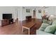 Inviting living room featuring hardwood floors, a cozy sofa, TV console, and open layout at 147 Bluff View Dr # 206, Belleair Bluffs, FL 33770