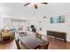 Inviting living room featuring hardwood floors, ceiling fan, dining table, and balcony access at 147 Bluff View Dr # 206, Belleair Bluffs, FL 33770