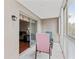 A relaxing sunroom patio featuring a sliding door entry, neutral walls, and stylish seating with a view of the outside at 147 Bluff View Dr # 206, Belleair Bluffs, FL 33770