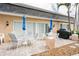 Inviting outdoor patio with dining sets and stylish patio umbrellas, perfect for relaxing and entertaining at 147 Bluff View Dr # 206, Belleair Bluffs, FL 33770