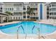 Sparkling pool with convenient stair access and lounge chairs at 147 Bluff View Dr # 206, Belleair Bluffs, FL 33770