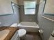 Bathroom featuring a tub, shower, toilet, and a granite-topped vanity cabinet at 212 S Church Ave # 105, Tampa, FL 33609