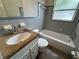 Bathroom featuring tub and shower combination plus vanity with granite countertop at 212 S Church Ave # 105, Tampa, FL 33609