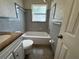 Bathroom features a tiled shower/tub combo, granite countertop, and integrated sink at 212 S Church Ave # 105, Tampa, FL 33609