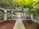 Covered carport featuring a courtyard with plants and tropical trees at 212 S Church Ave # 105, Tampa, FL 33609