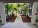 Exterior shot of a landscaped courtyard and covered parking area at 212 S Church Ave # 105, Tampa, FL 33609